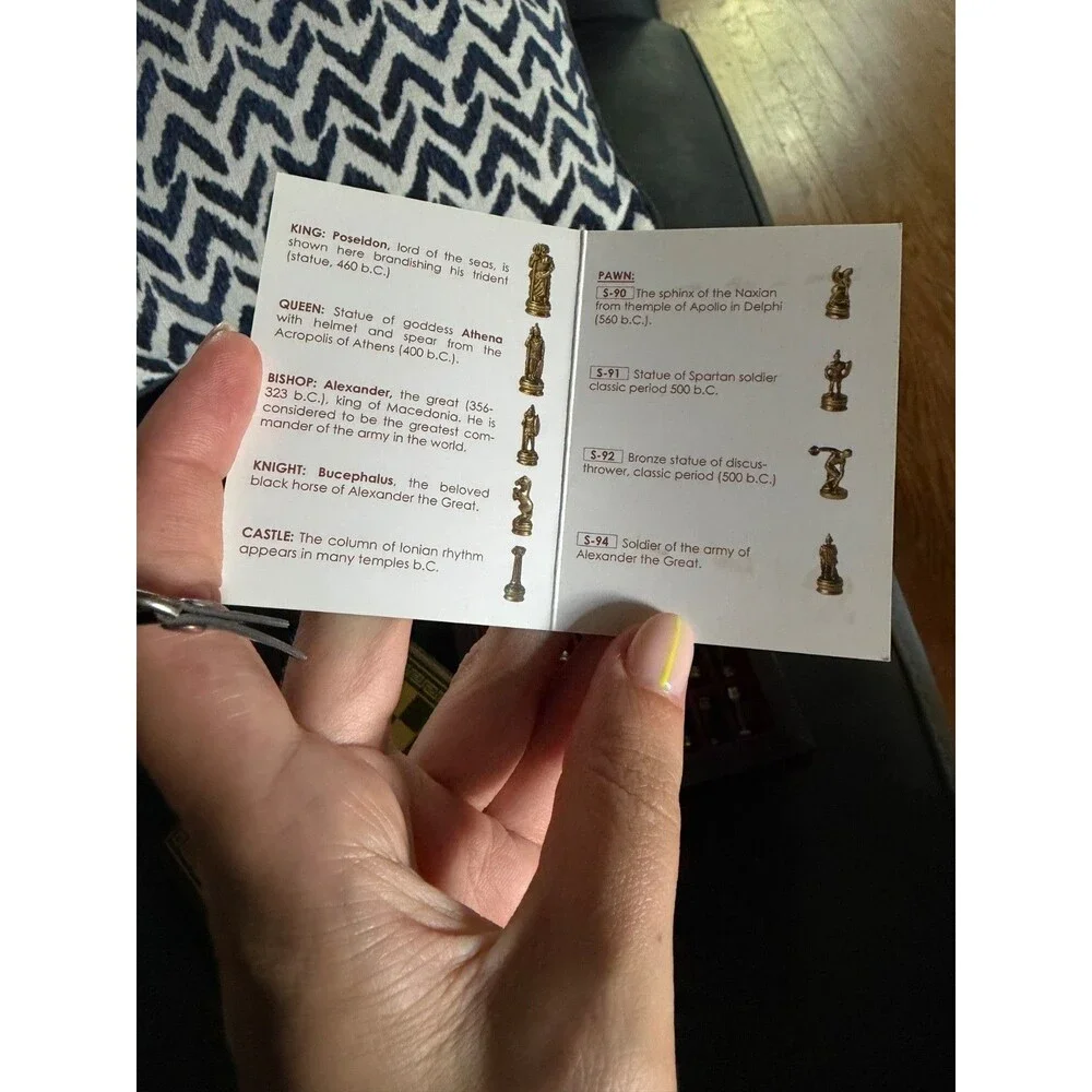 manopoulos chess set with Greek mythology pieces and guide.